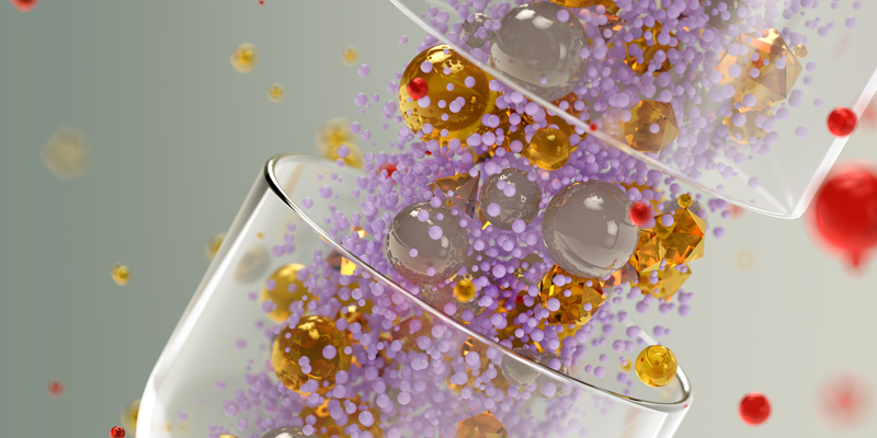 Digitally rendered gel capsule filled with multicolor spheres.