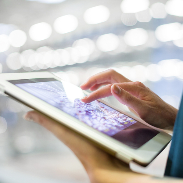 Cropped image of businesswoman using digital tablet in office