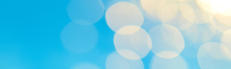 Soft focus bokeh light effects over a rippled, blue water background in the pool.